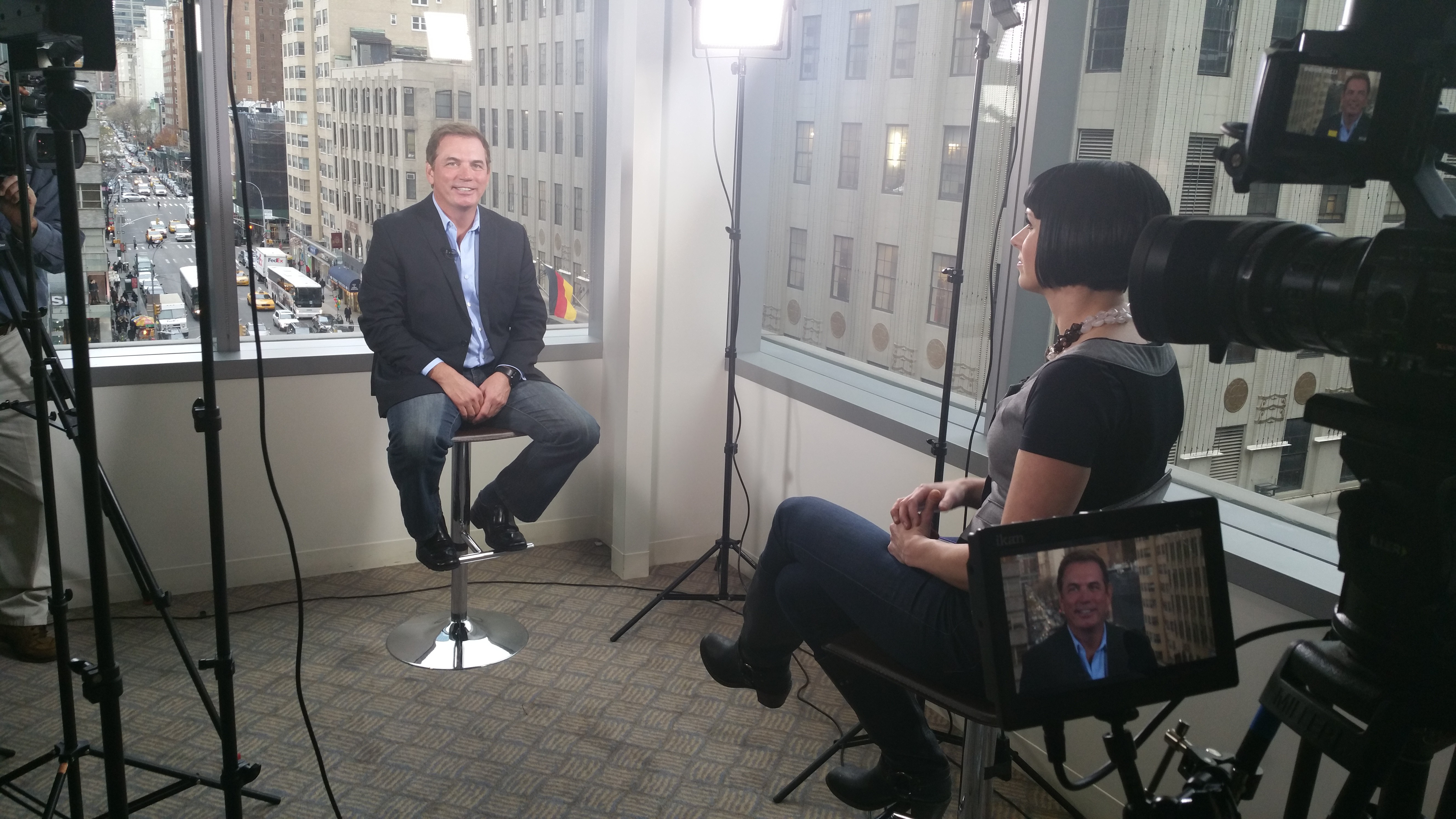 Mike Warren being interviewed in New York City with Manhattan skyline